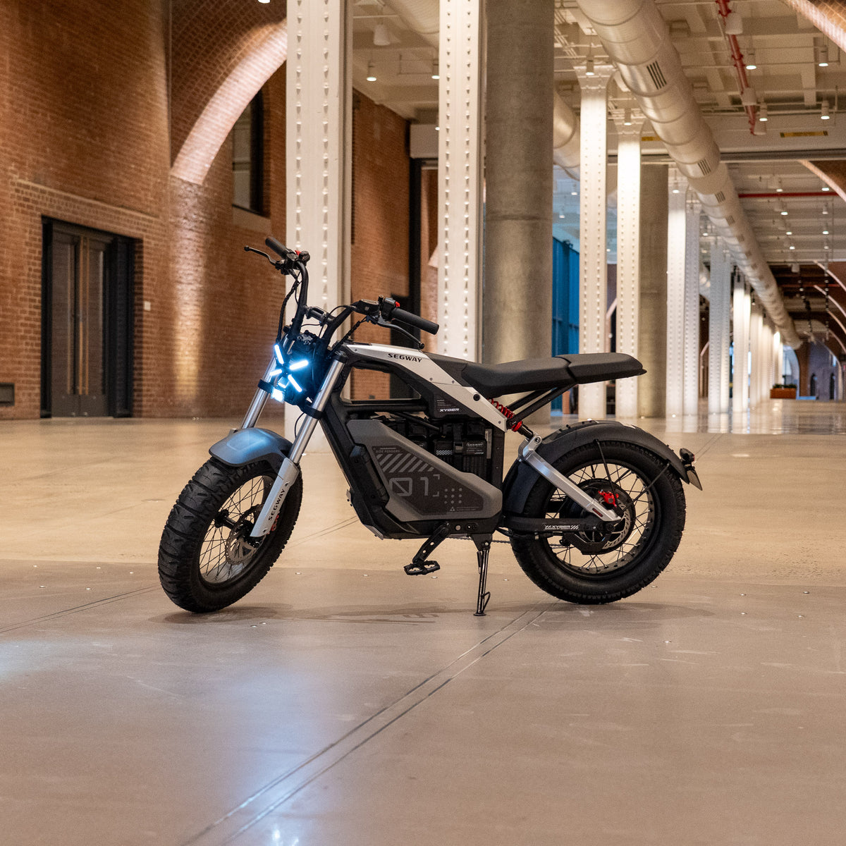 Segway Xyber Air electric bike in silver, side profile with headlight on