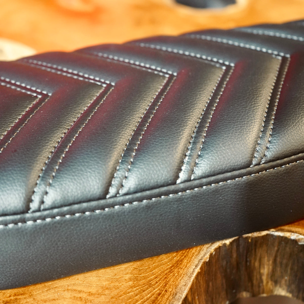 Close up of the stitching pattern on the synthetic leather seat.