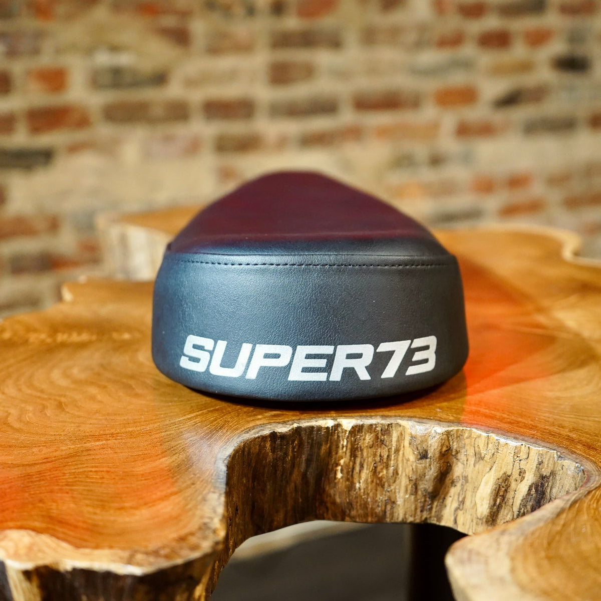 Close up of the Super73 logo on the rear of the seat. 